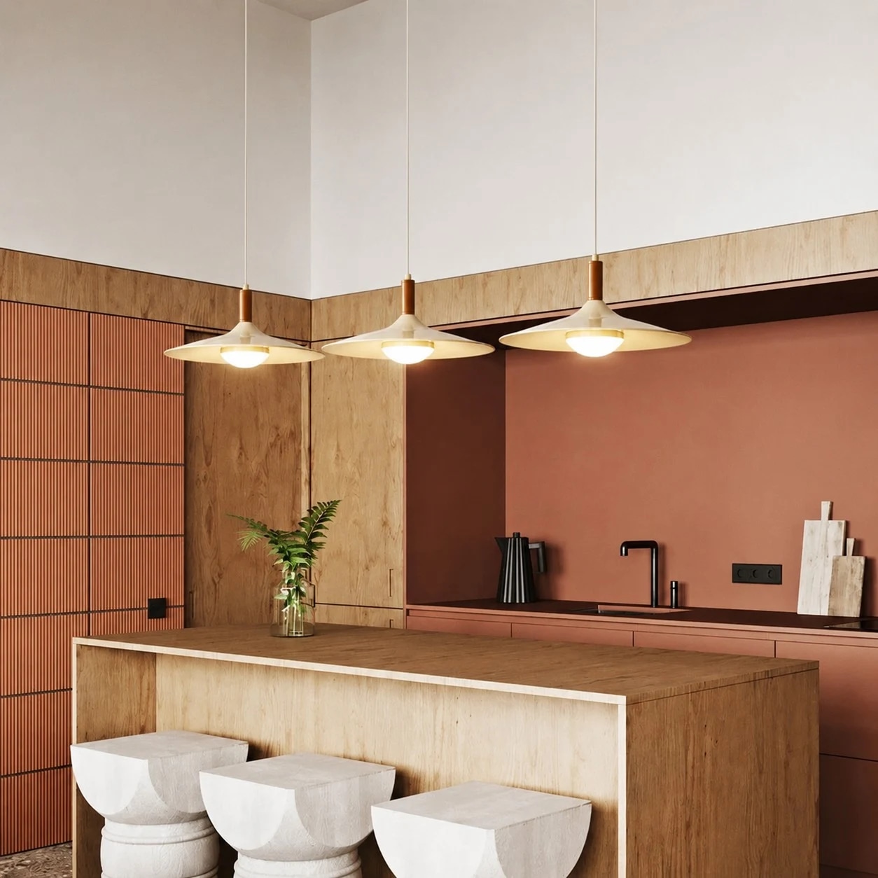 Three cream pendant lights installed above a kitchen island