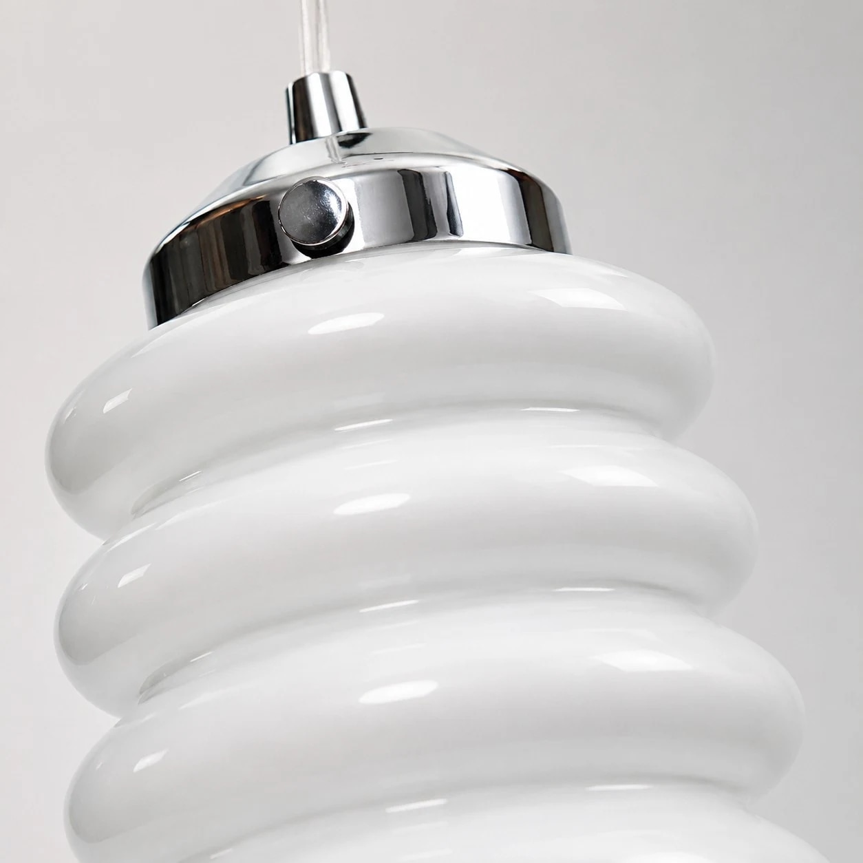Close view of chrome cap and white ribbed glass shade