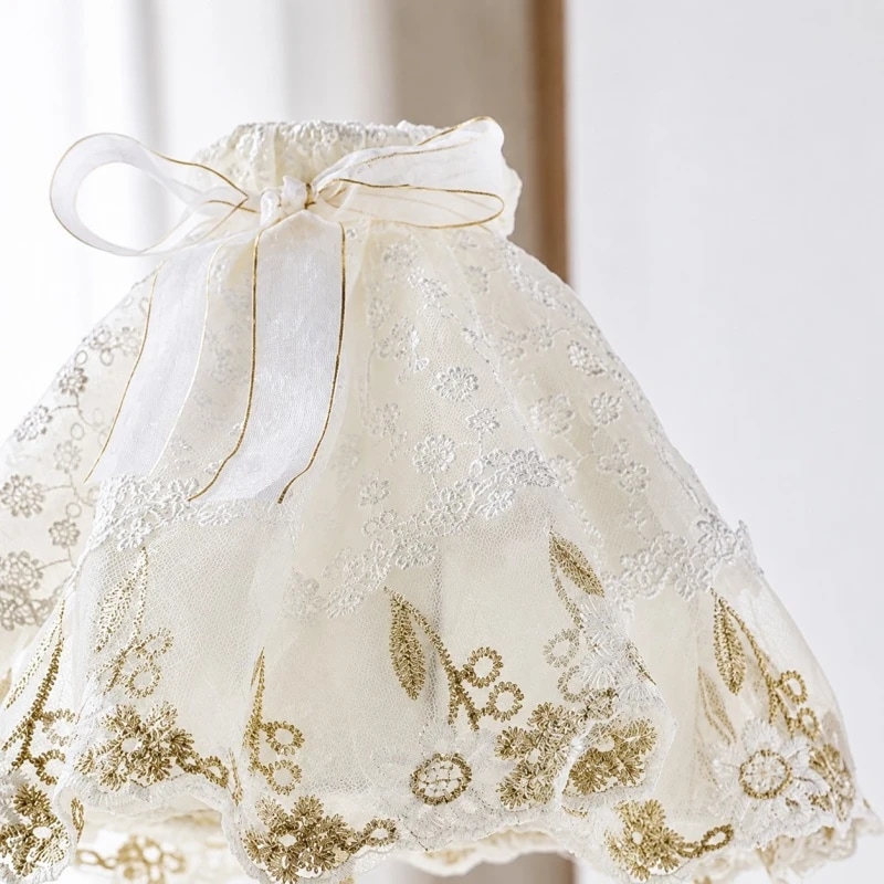 Embroidered lace shade with bow and floral stitching