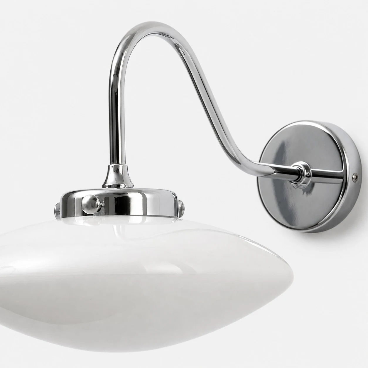 Curved arm and round wall plate detail of the glass wall sconce