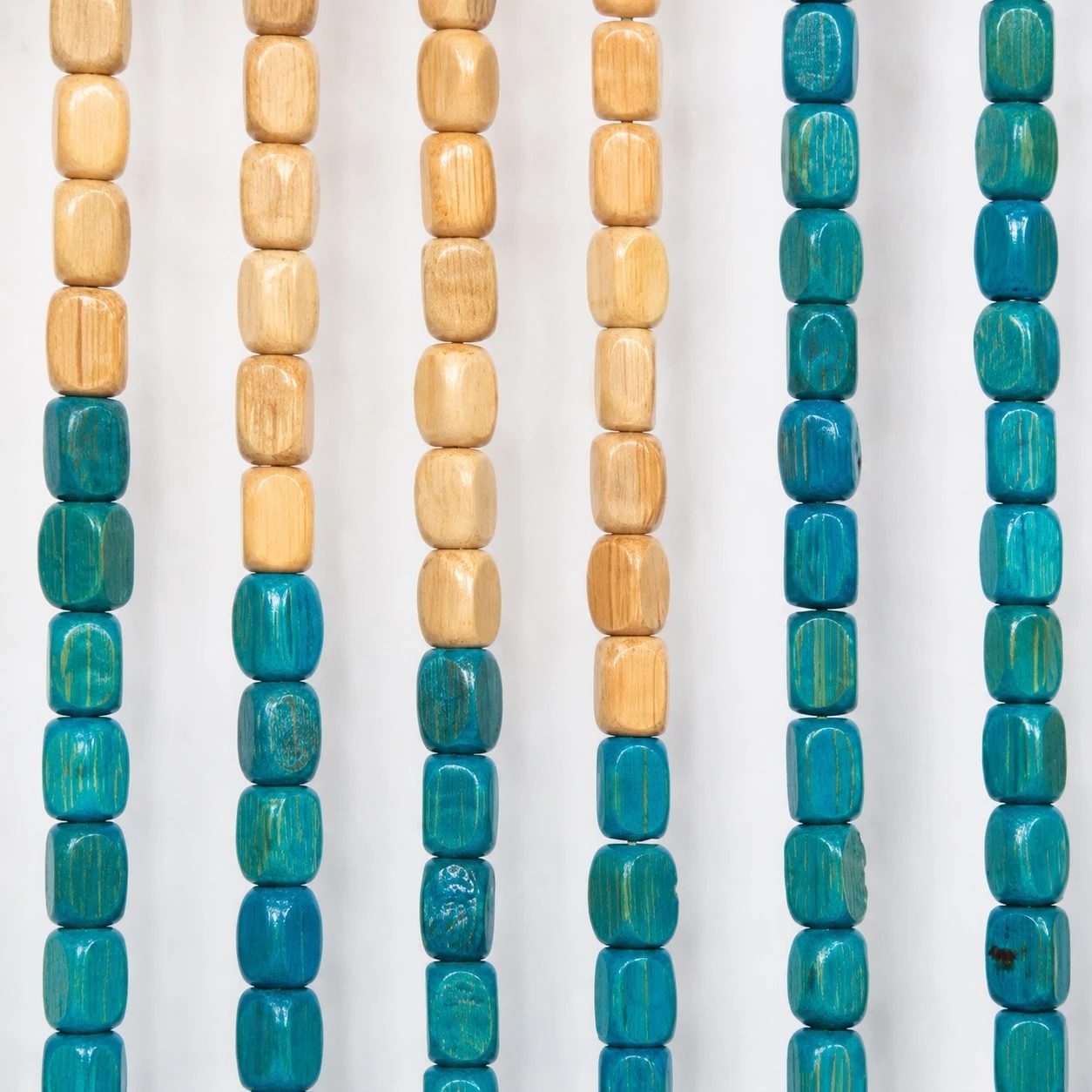 Tan and teal wood bead close-up