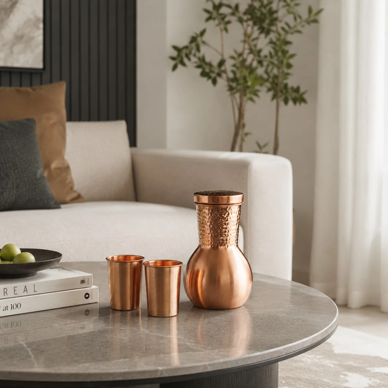 Copper kettle and cups styled on a living room table